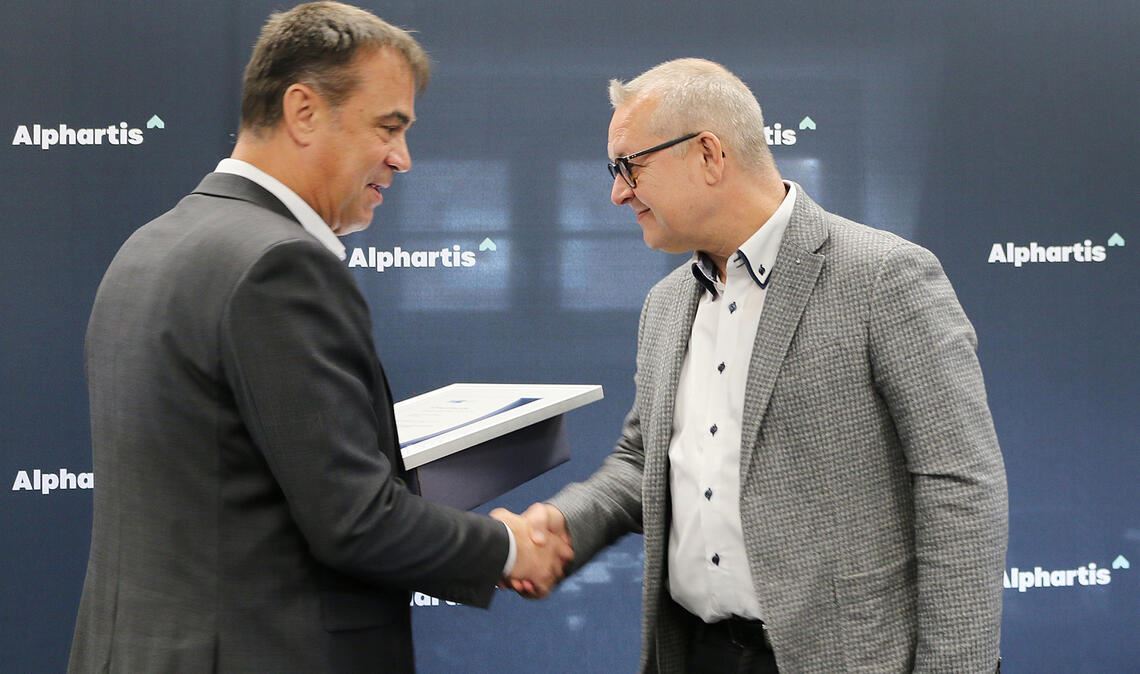 Albrecht Wollensak, Vorstandsvorsitzender der Alphartis SE (li.), beglückwünscht Jochen Staib zum Betriebsjubiläum und überreicht eine Ehrenurkunde. Foto: Alphartis SE