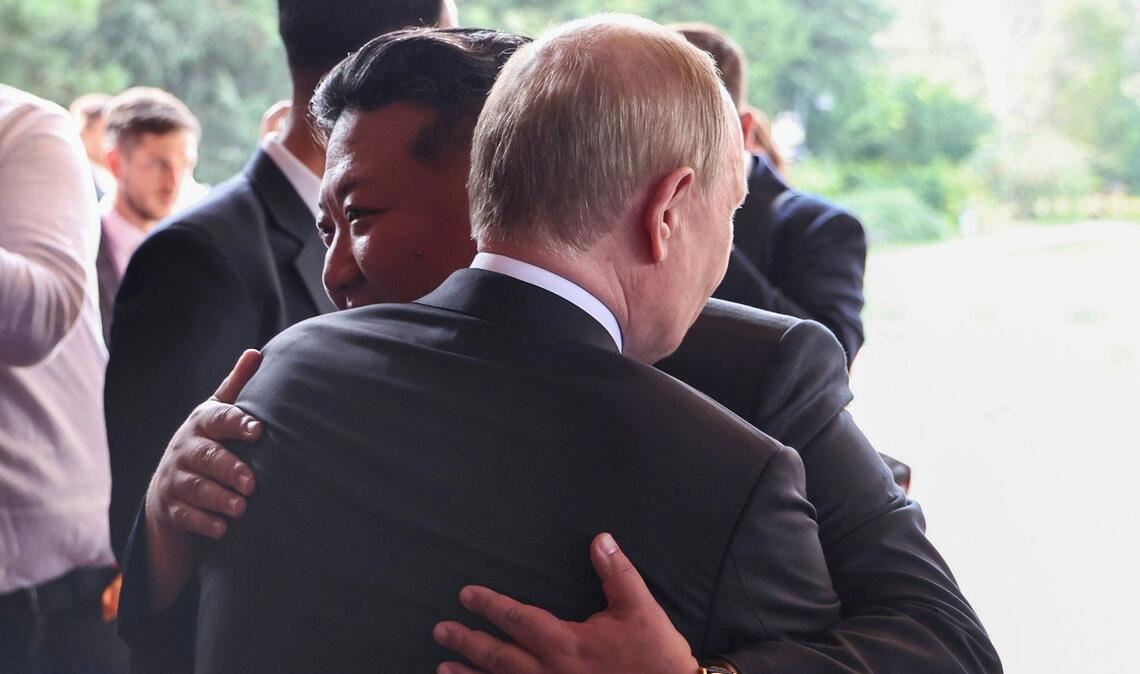 Auf diesem von der staatlichen russischen Nachrichtenagentur Sputnik via AP veröffentlichten Foto umarmen sich der russische Präsident Wladimir Putin (vorn) und der nordkoreanische Machthaber Kim Jong Un nach ihrem Treffen im Staatlichen Gästehaus Diaoyutai in Peking.