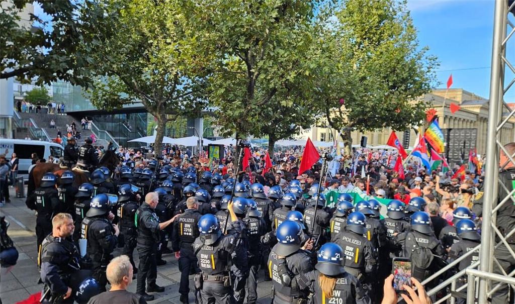 Bei der Rede von Sevim Dağdelen bewegen sich plötzlich Vermummte in Richtung der Bühne. Die Polizei muss eingreifen.