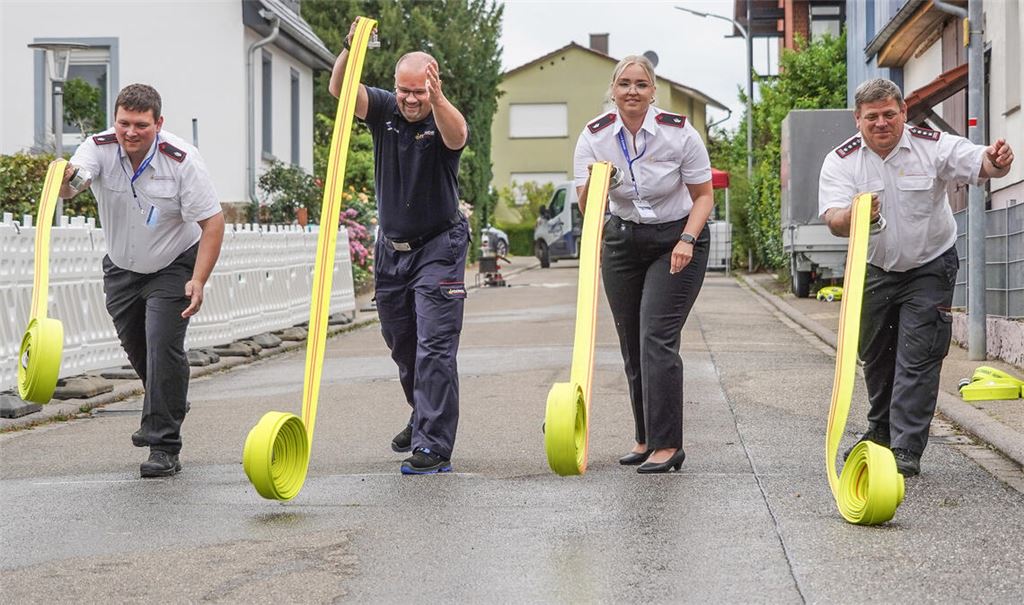 Beim Pokalwettkampf machen Jérémie Paupy, Kreisbrandmeister Carsten Sorg, Stefanie Dörr und der Kieselbronner Kommandant Matthias Poppe (v.li.) den Jugendlichen vor, wie das Ausrollen eines Schlauchs geht. Foto: Roller