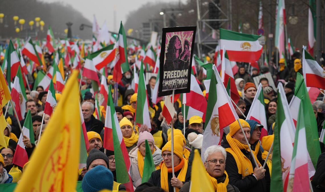 Demonstranten mit Plakaten und Transparenten am Brandenburger Tor in Berlin.
