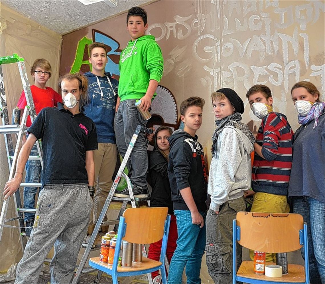 Der Ötisheimer Künstler Sven Bruxmeier (2.v.li.) und Schulsozialarbeiterin Stefanie Schneider (re.) gestalten im Rahmen der Projektwoche mit Schülern ein Graffito für den Aufenthaltsraum der Ulrich- von-Dürrmenz-Schule. 