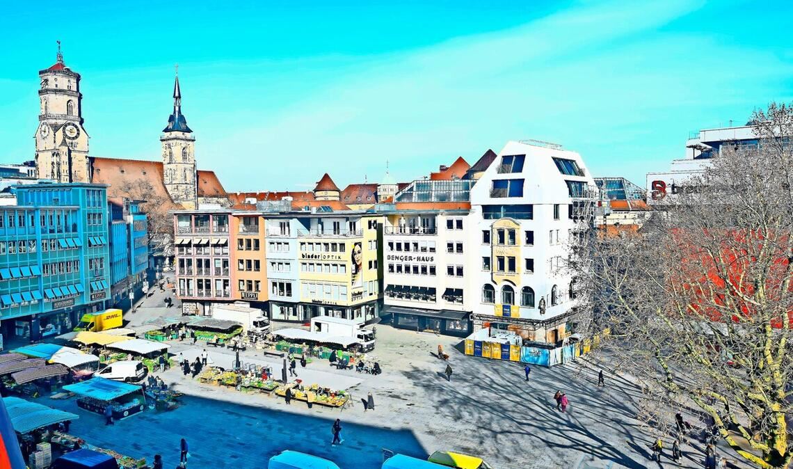 Der Stuttgarter Marktplatz mit einem Eckhaus, das hoch hinaus will, dahinter das gläserne Dach der beliebten Markthalle.