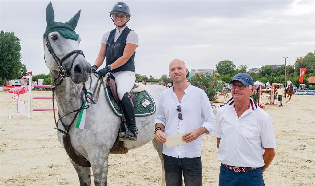 Die Zweitplatzierte des S-Springens, Anne Götter auf „Classe Lady“ mit Frank Hanakam von der Sparkasse und dem Vereinschef und Geburtstagskind Uli Burger (re.). Foto: Fotomoment
