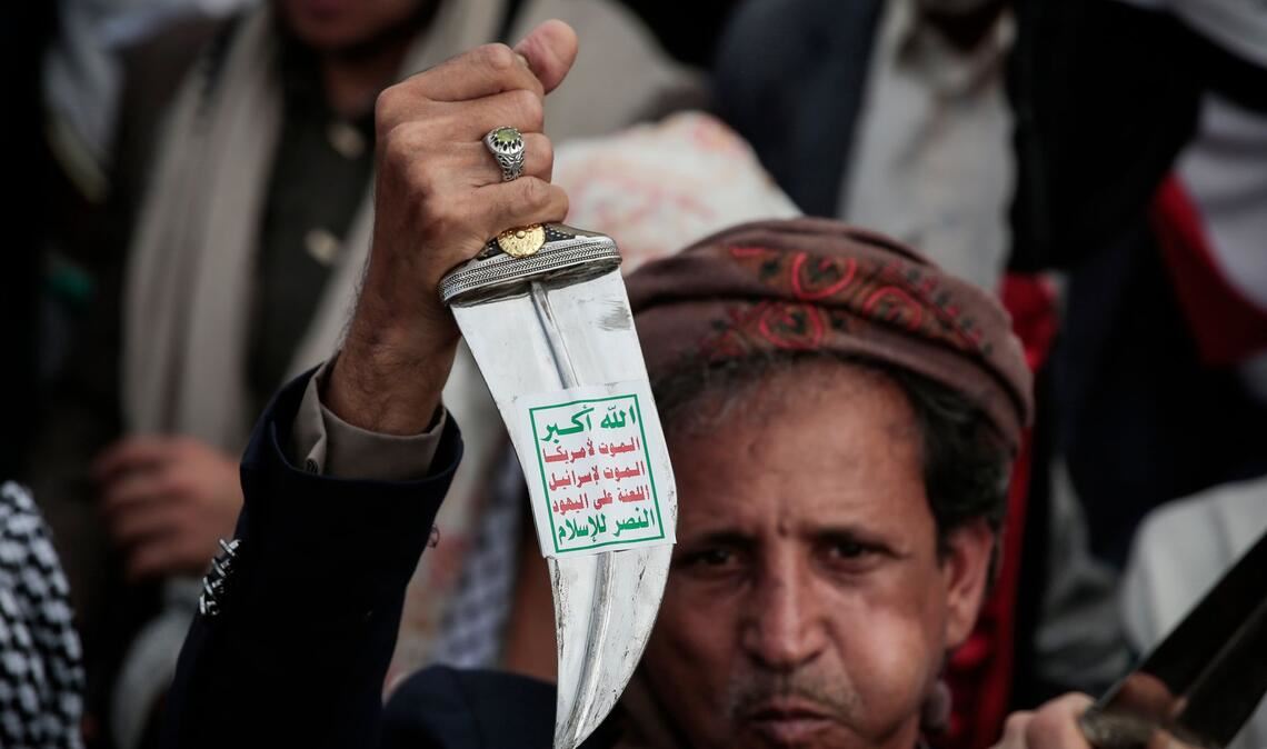 Ein Huthi-Anhänger hebt einen traditionellen jemenitischen Dolch (Jambiya) mit dem Huthi-Slogan (Sarkha), der übersetzt "Allah ist der Größte, Tod für Amerika, Tod für Israel, Fluch über die Juden, Sieg für den Islam" bedeutet, während einer Demonstration in Sanaa.