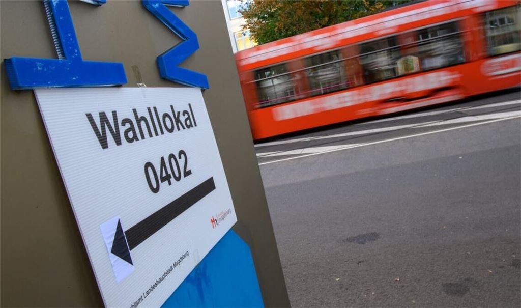 Ein Schild weist den Weg zu einem Wahllokal. Am Sonntag wird in Sachsen-Anhalt ein neuer Landtag gewählt. Die Vorbereitungen in den Wahllokalen hatten am Morgen begonnen.