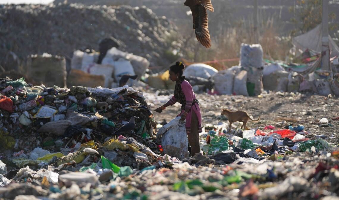 Eine Frau sucht auf einer Mülldeponie im indischen Jammu nach etwas Verwertbarem.