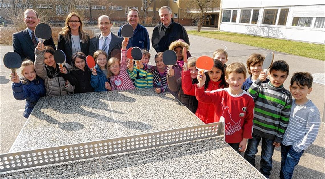 Eric Großmann und Nelli Schmid von der Volksbank Pforzheim, Bürgermeister Harald Eiberger, Heinrich Sibert vom SV Illingen und Schulleiter Andreas Petermann (hinten v. li.) weihen gemeinsam mit Schulkindern die neue Tischtennisplatte ein.