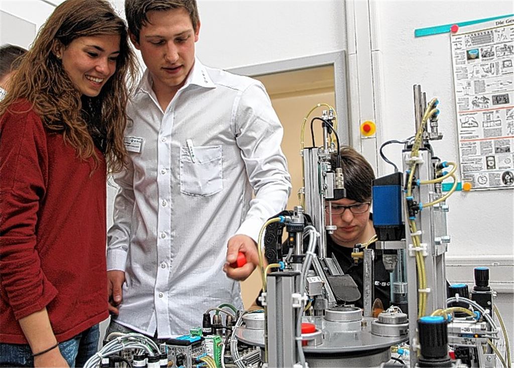 Erklärungen zur Miniaturfertigungsanlage erhalten die interessierten Besucher.