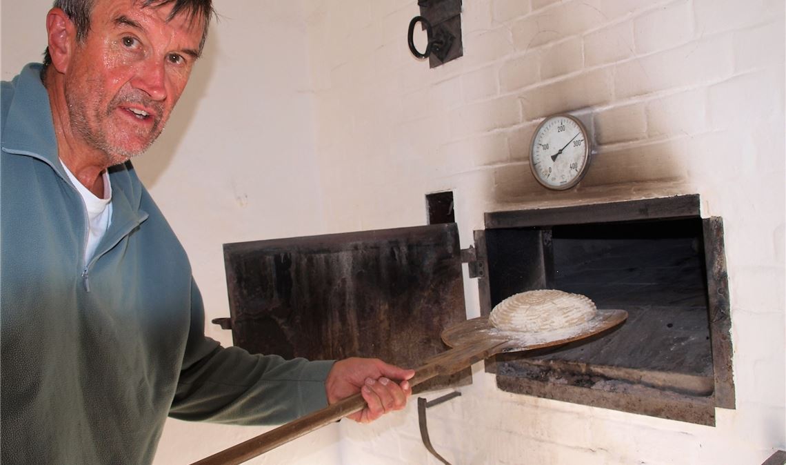 Ein Brotlaib aus dem historischen Ofen Fast 280 Grad zeigt das Thermometer als der Vorsitzender Gerhard Eitel den ersten rohen Brotlaib in den heißen Ofen schiebt – zum Schutz in einem langärmeligen Oberteil. Fotos: Filitz