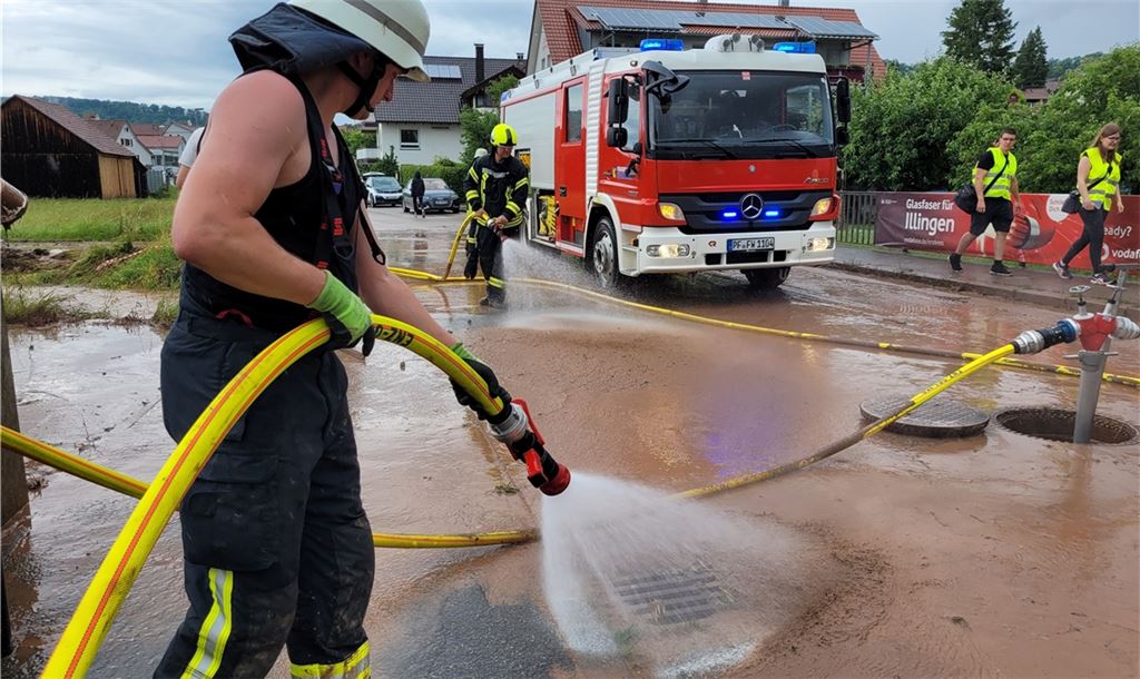 Feuerwehr spült den Schlamm von der Hauptstraße in Schützingen.
