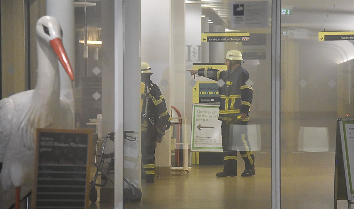 Feuerwehrleute machen sich in den verrauchten Räumen der Notaufnahme ein Bild. Ob der Patient an einer Rauchvergiftung starb, soll die Obduktion klären. Fotos: Myroshnichenko