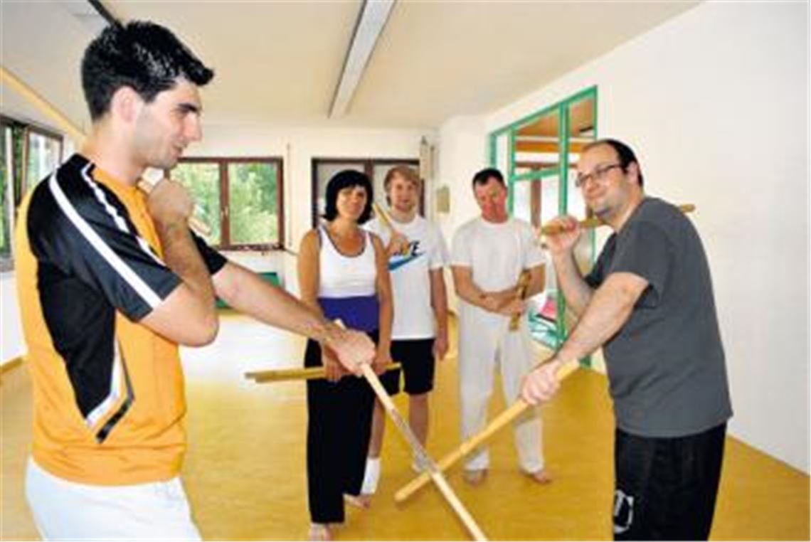 Florian Knapper (im dunklen T-Shirt) unterrichtet in Mühlacker Tactical Solutions for Defense, ein modernes und vielfältiges Selbstverteidigungssystem. Mit den Doppelstöcken trainieren die Sportler beispielsweise ihre Augen-Hand-Koordination. Foto: Stahlfeld