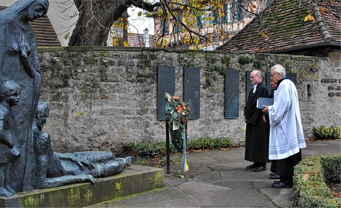 Franz Hebeda, Johann Sturm und Pfarrer Wolfgang Schlecht (v. re.) vor dem Illinger Ehrenmal.