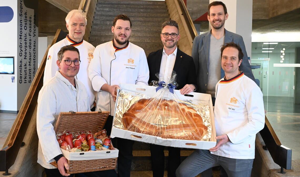 Handwerker überreichen im Rathaus in Pforzheim die „Neujahrsgabe“ (v. li.): Armin Dobler (Fleischer-Innung), Martin Reinhardt (Bäcker), Janis Wiskandt (Bäcker), Oberbürgermeister Peter Boch, Landrat Bastian Rosenau und Ralf Jäckle (Bäcker). Foto: Bott
