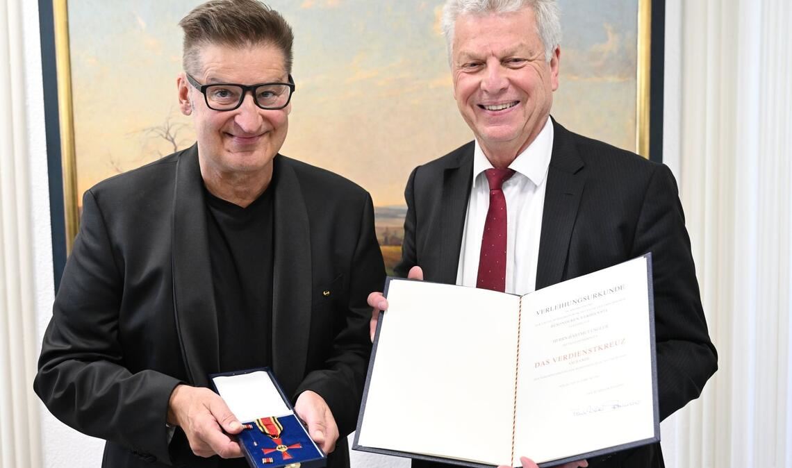 Hartmut Engler (links) und der Oberbürgermeister von Bietigheim-Bissingen, Jürgen Kessing mit dem Bundesverdienstkreuz und der dazugehörigen Urkunde.