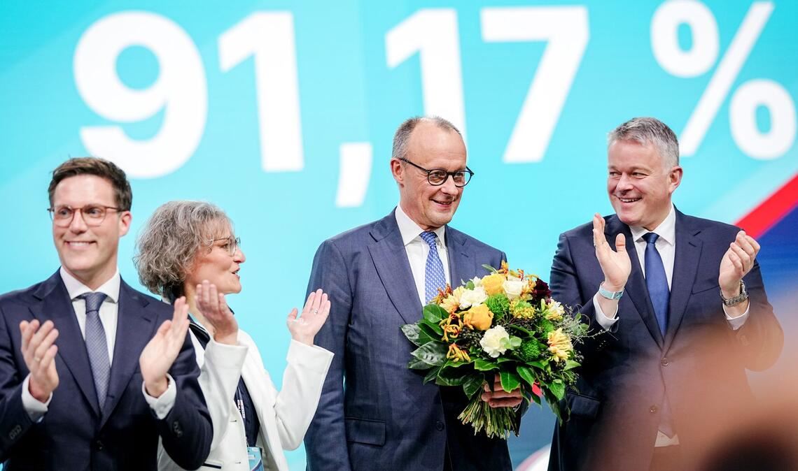 Ina Scharrenbach, Sitzungsleiterin, Gordon Schnieder (r), Spitzenkandidat der CDU in Rheinland-Pfalz, und Manuel Hagel (l), Spitzenkandidat der CDU in Baden-Württemberg, gratulieren Bundeskanzler Friedrich Merz, CDU-Parteivorsitzender, zur Wahl zum Bundesvorsitzenden.