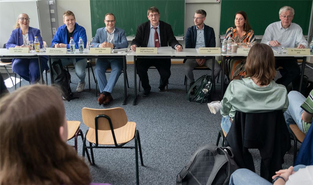 Jürgen Gorenflo (Mitte) moderiert eine Podiumsdiskussion zur Europawahl, an der Tanja Hilton (Die Linke, v.li.), Emil Schenkyr (Grüne) und Davis Riedel (SPD) sowie Dr. Thomas Fink (AfD, v.re.), Nadine Petri (CDU) und Johannes Baumbast (FDP) teilnehmen und Schülerfragen beantworten. Foto: Fotomoment