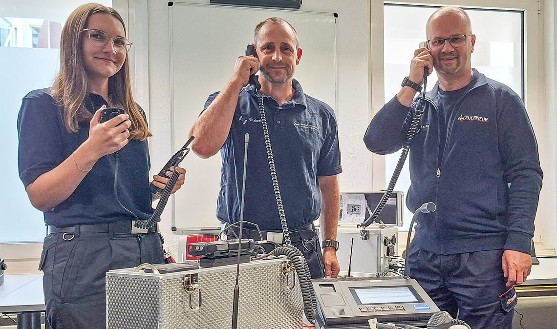 Kreisbrandmeister Carsten Sorg (re.) und die beiden Fachleute für Kommunikations- und Alarmierungstechnik im Landratsamt, Boris Bader und Leonie Guth, freuen sich über die neue Funktechnik im Enzkreis. Foto: Enzkreis, Christian Thümmel