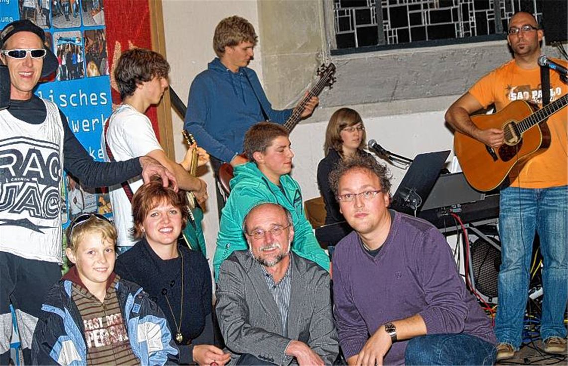 Manfred Geywitz mit Sohn, die Band Crossroad sowie, sitzend, Petra Reusch, Pfarrer Schlecht und Jugendpfleger Gutekunst (v. li.). 