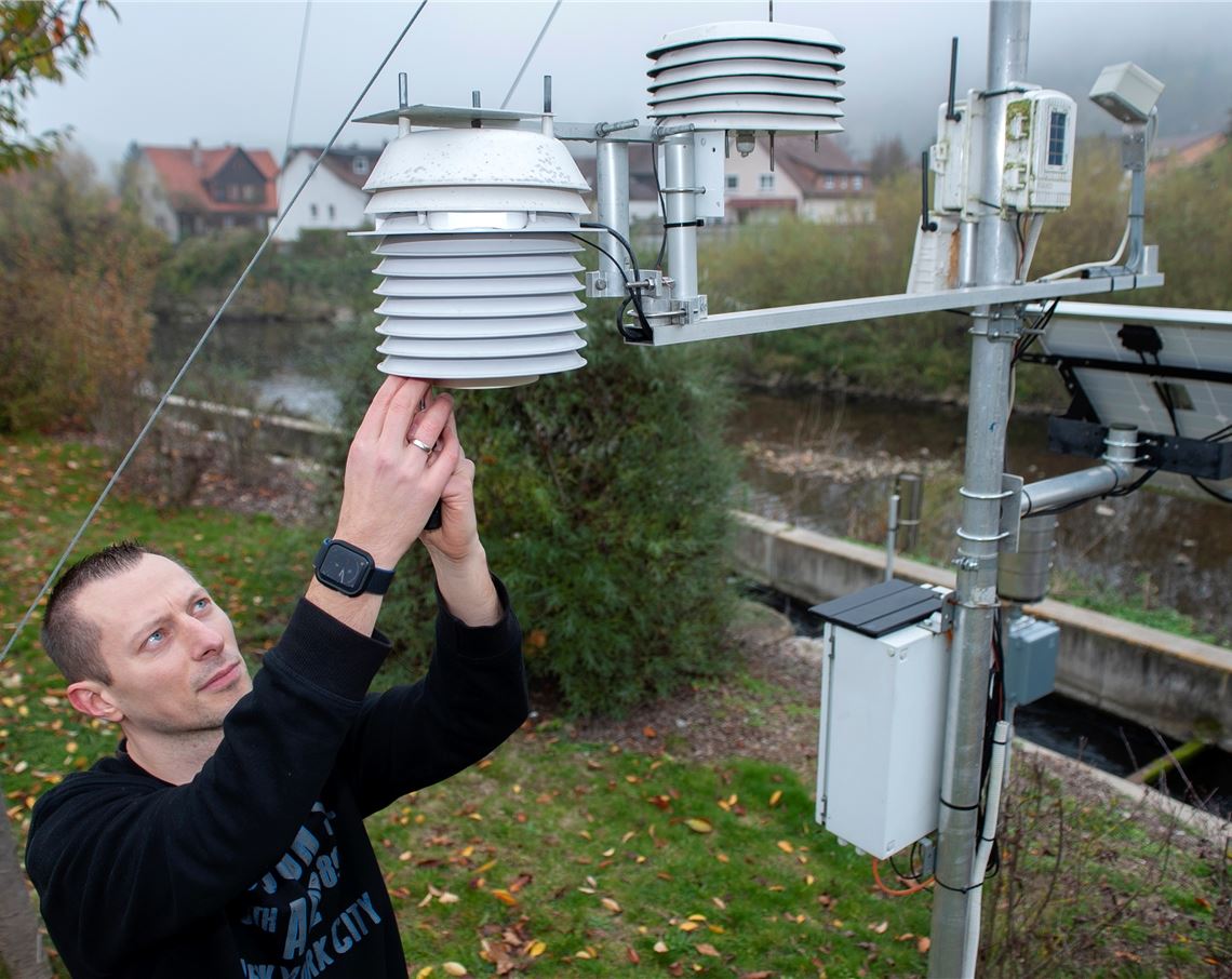 Marcel Segel an seiner Wetterstation auf dem Gelände des Wasserkraftwerks.Foto: Fotomoment