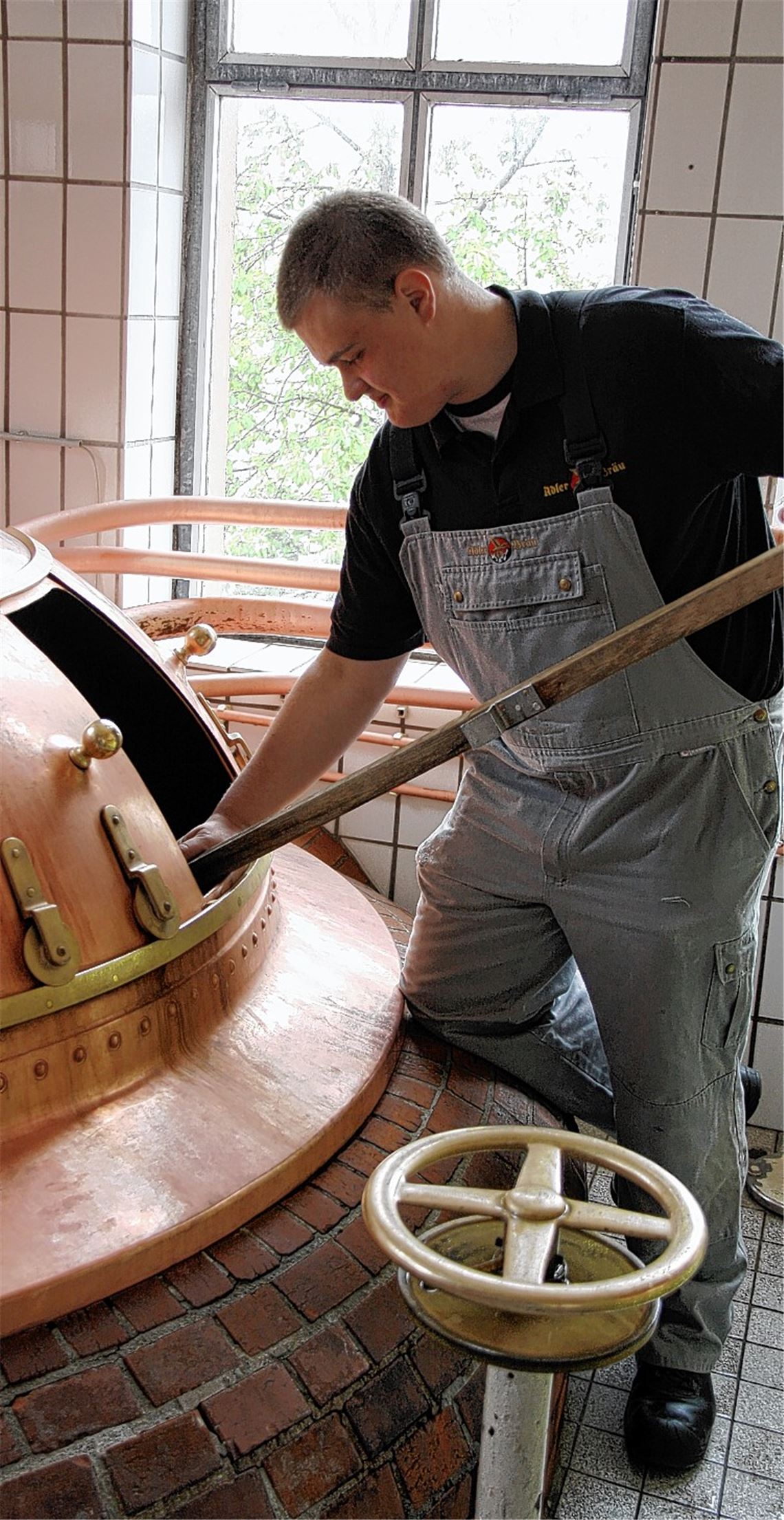 Mit einem Prüfstab testet Leopold Volk, ob sich Malz im Maischebottich gelöst hat.