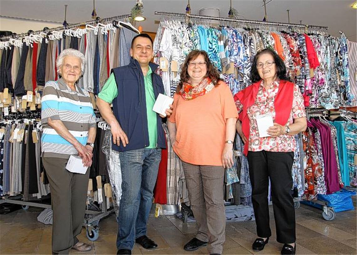 Mittendrin statt nur dabei – Heimleiter Arno Greilich posiert mit den anderen „Models“ der DRK-Modenschau vor der mitgebrachten Kleiderauswahl.