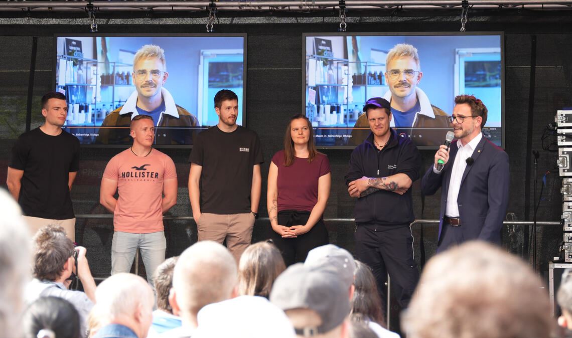 OB Boch (re.) beim Finale der Fernsehaufzeichnung in Brötzingen mit – auf dem Bildschirm – seinem blondierten Alter Ego. Foto: Stadt Pforzheim