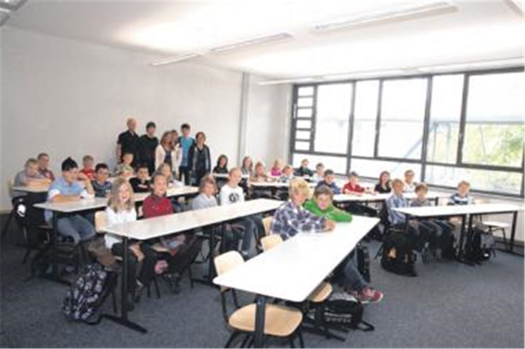 Premiere im Klassenzimmer: Die Fünftklässler, hier mit Klassenlehrern und Schulpaten, starten ihre Schulkarriere am THG. Fotos: Gollnow