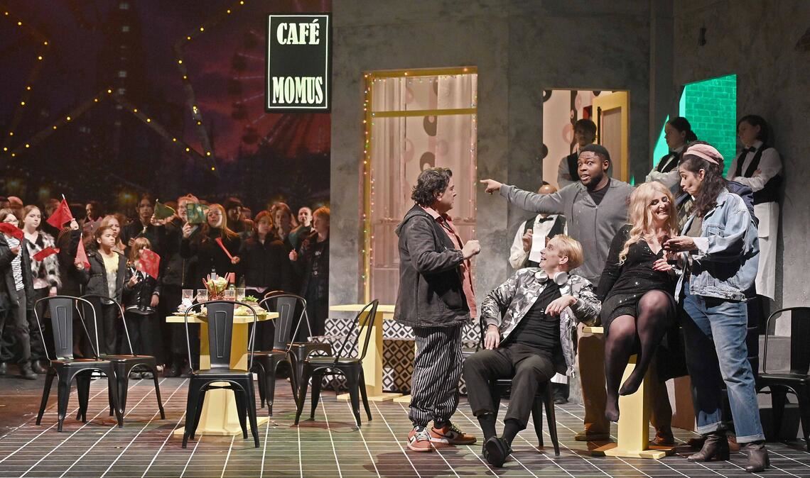 Quirliges Treiben: Szene aus „La Bohème“ beim Auftritt der Chöre mit Kindern und Jugendlichen in einer beeindruckenden Kulisse. Foto: Theater Pforzheim/Jochen Klenk