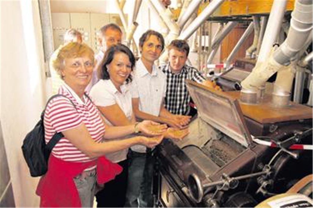 Reinfassen verboten: Klaus Dobler (2. v. re.) von der Störrmühle zeigt, wie Korn gewalzt wird. 