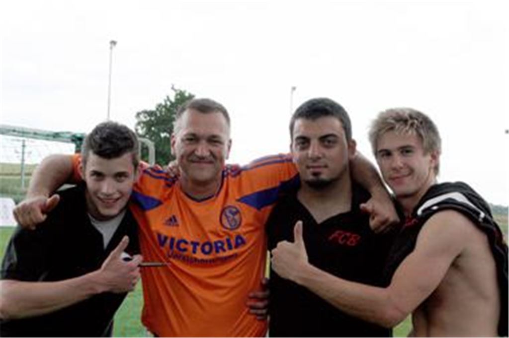Rivalen vertragen sich: Der Schalker Peter König (2. v. li.) mit seinen ehemaligen Handball-Schülern, den Bayern Aaron Deess, Muharrem Aydin und Michael Hörandel (v. li.) Foto: Westermann