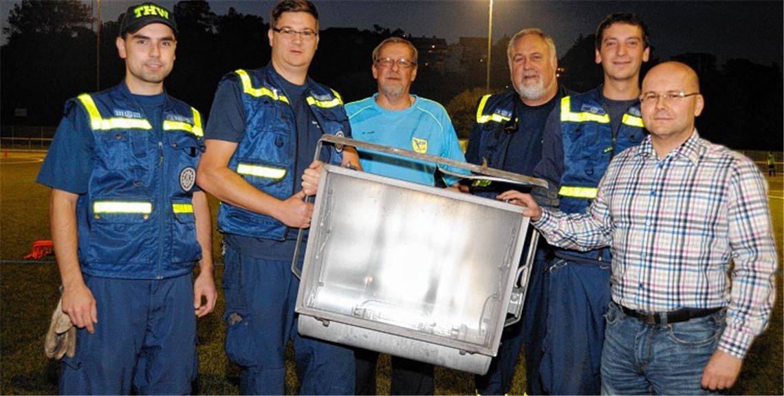 Sascha Talmon, Tobias Gutscher, Steffen Bandle (v.re.) und Jochen Palmer sowie Matthias Ruhland vom THW-Mühlacker bekommen sechs Flutlichter von Wolfgang Gutscher (v.li.) vom TSV Phönix Lomersheim.