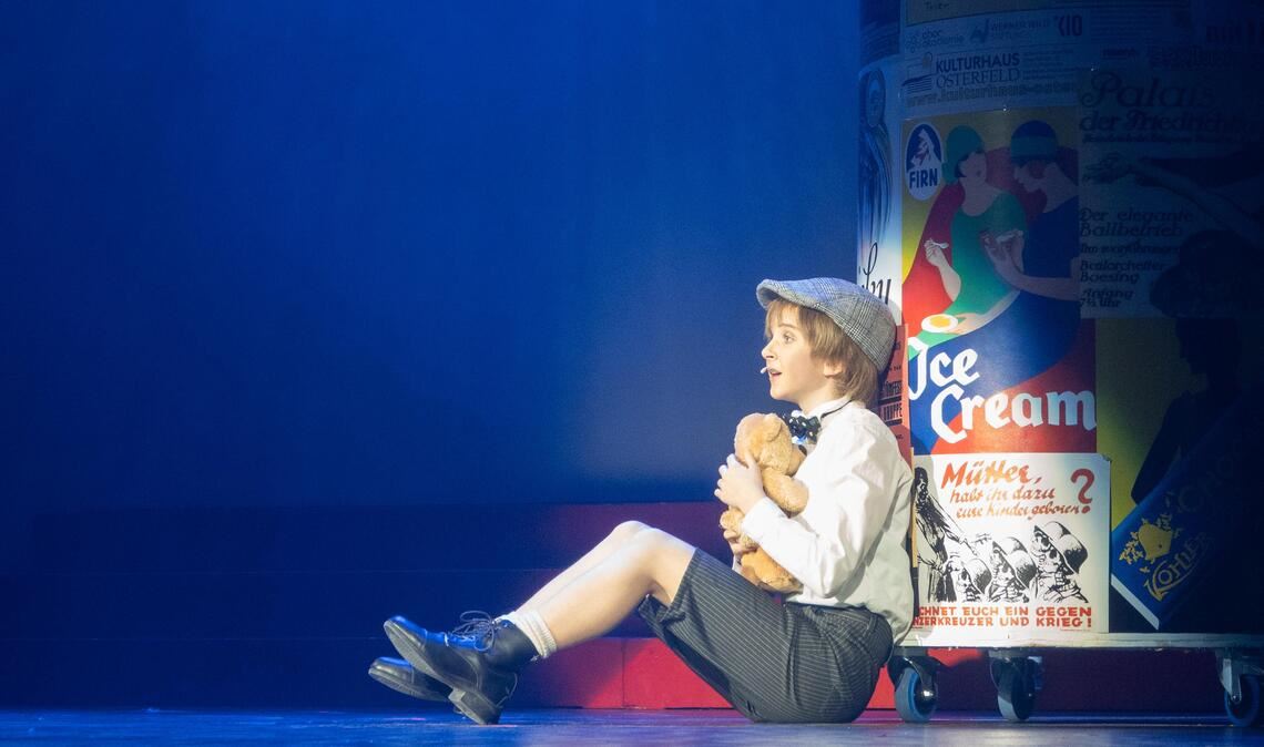 Seine erste Nacht in Berlin verbringt Emil (Jessica Kania) ganz allein mit seinem Teddybären. Foto: Volz