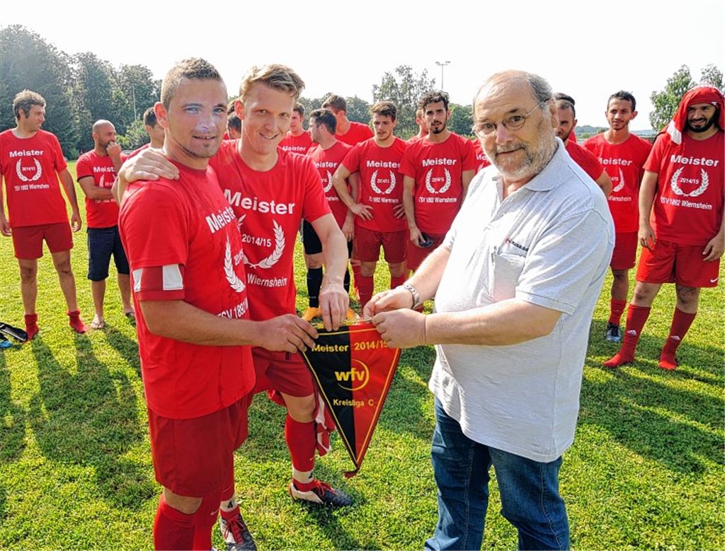 Staffelleiter Bernd Stäcker übergibt den Meisterschaftswimpel an Wiernsheims Andreas Wieser und Mannschaftskapitän Sandro Zundel (vorne v. li.).