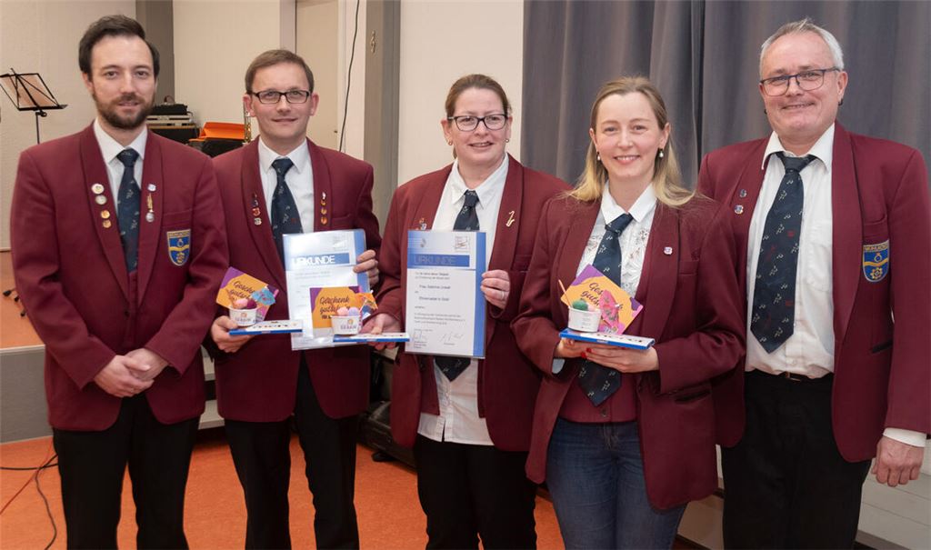 Stefan Bosch (li.) und Ehrenvorstand Markus Rössle (re.) ehren die aktiven Musikerinnen und Musiker Christian Werner, Sabrina Unselt und Lena-Marie Scheytt (v. li.) für ihre langjährige Mitwirkung im Orchester. Foto: Fotomoment