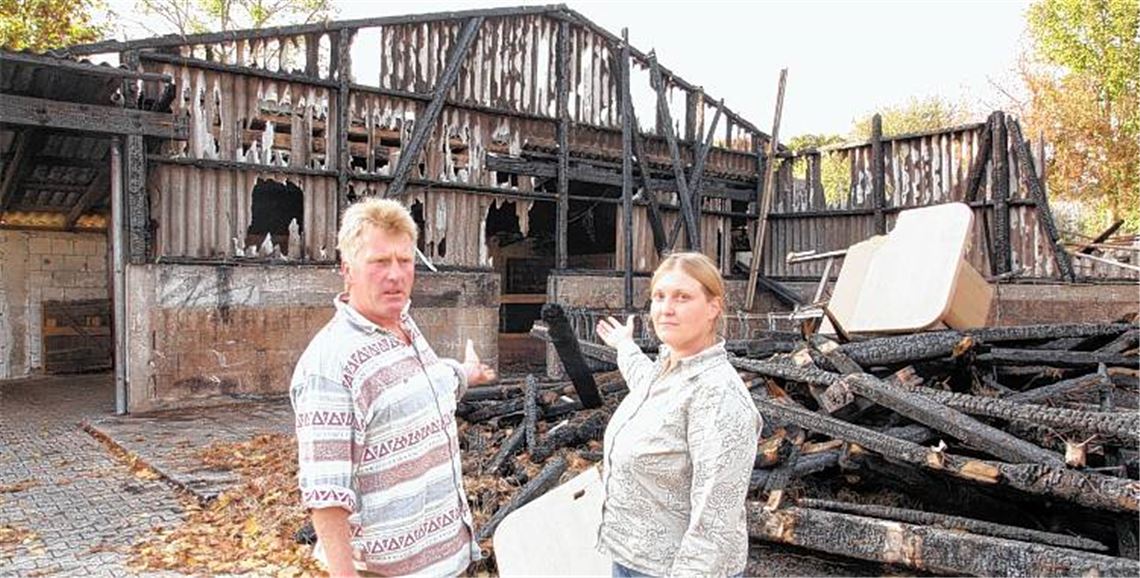 Stefanie und Albrecht Rommler vor der Brandruine, die früher einmal eine große Scheune für Tiere, Futter und Maschinen war. 