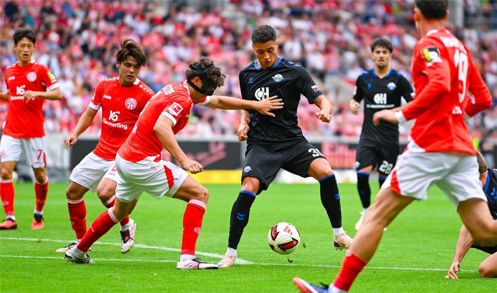 Umringt von viel Rot: Stefano Marino hat gegen die Mainzer Defensive einen schweren Stand, weiß sich bei seiner Bundesliga-Premiere aber zu behaupten. Fotos: Schüller