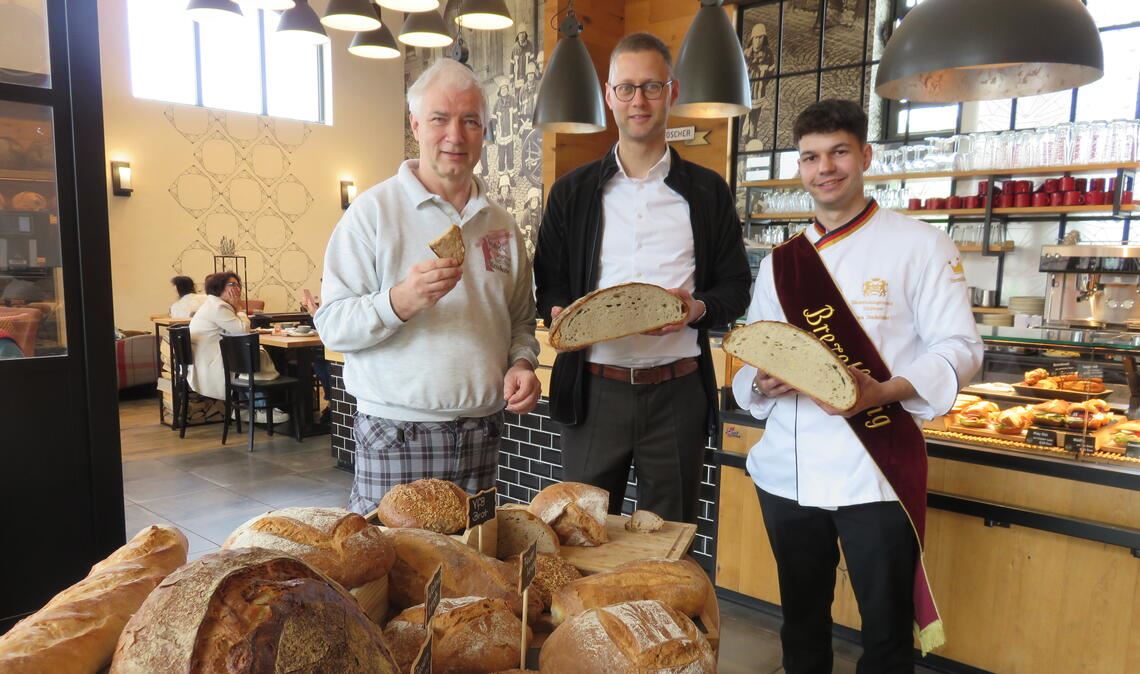 Verschiedene Brotsorten stehen am „Tag des Brotes“ in der „Alten Feuerwache“ in Knittlingen bereit. Martin Reinhardt (v.li.) lässt nicht nur Kunden, sondern auch Enzkreis-Dezernent Holger Nickel und Brezelkönig Luca Stadelhofer probieren. Fotos: Becker
