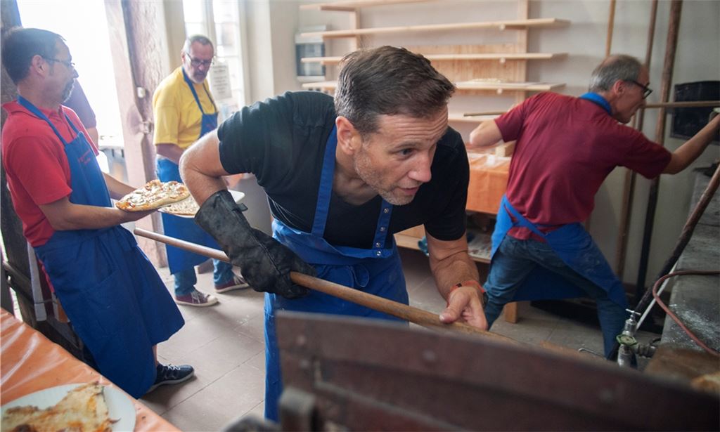 Voller Einsatz: Tobias Müller (vorne) hilft als Nicht-Vereinsmitglied beim Backhausfest des MGV Concordia Pinache mit. Foto: Fotomoment