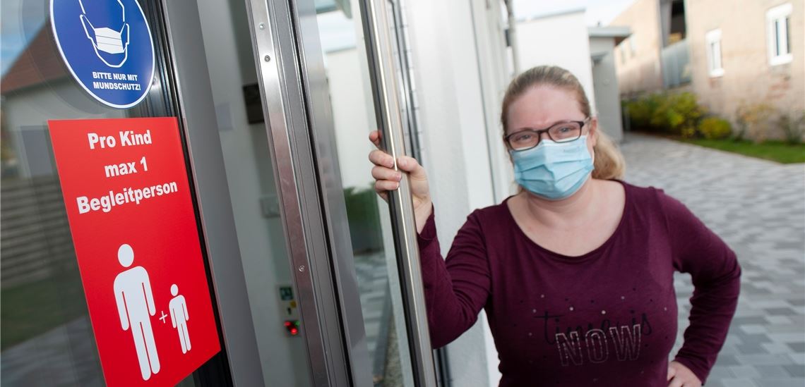 Vorschriftsmäßig mit Mund-Nasen-Bedeckung: Leiterin Ramona Common am Eingang der Kita im Käppele in Mühlacker.Foto: Fotomoment
