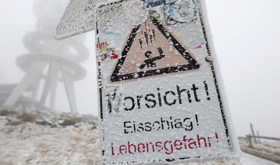 "Vorsicht Eisschlag" ist auf einem Hinweisschild auf dem Brocken zu lesen.