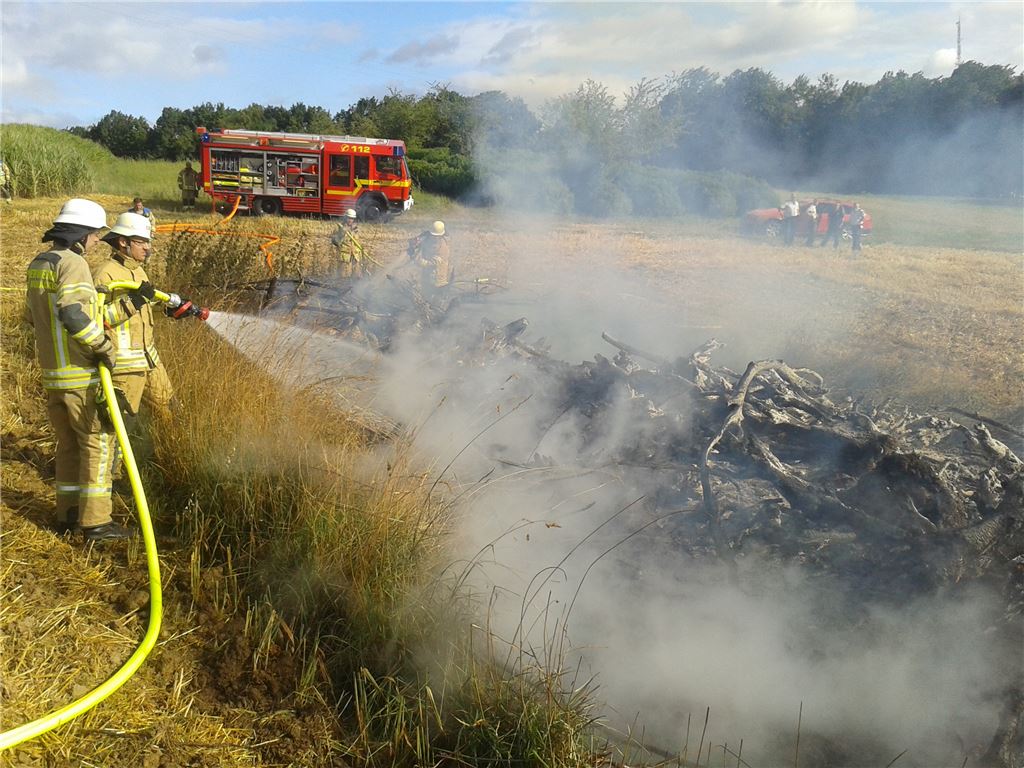 Vorsichtsmaßnahme: Angesichts der Trockenheit und des heftigen Windes löscht die Feuerwehr den brennenden Holzhaufen ab. Foto: Eier