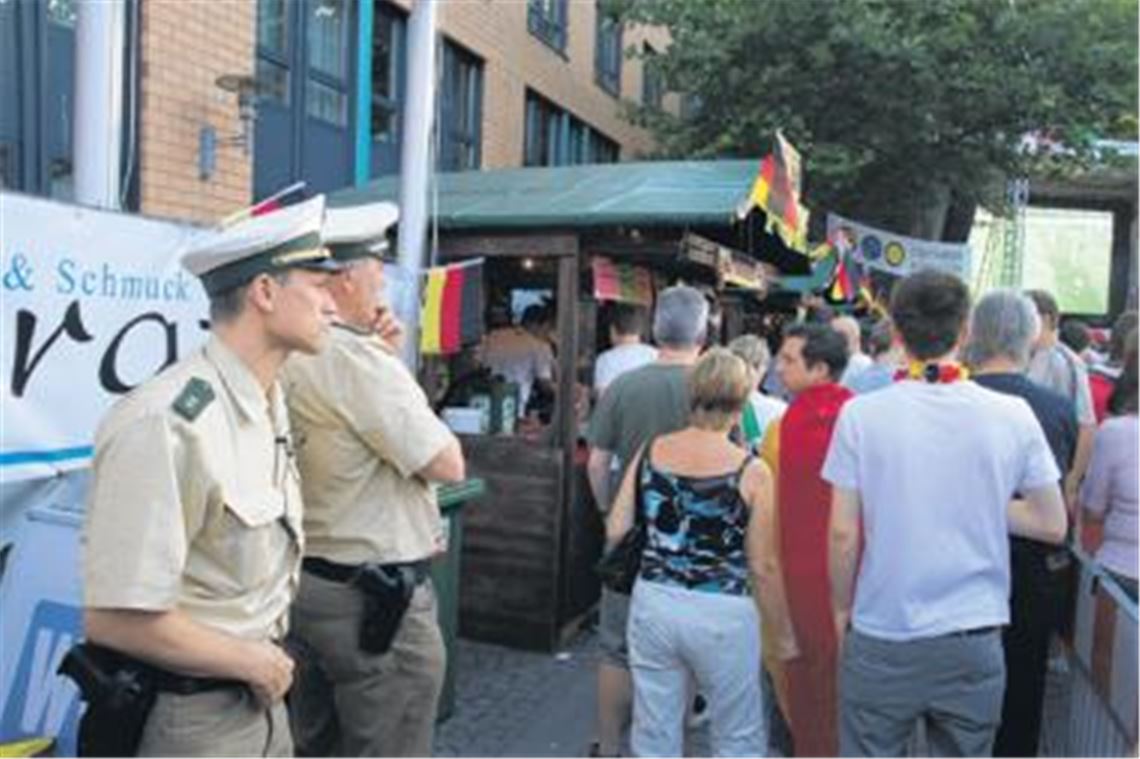 Während andere das Spiel genießen können, sorgt die Polizei mit zusätzlichen Beamten für Sicherheit bei den Publik Viewing-Veranstaltungen. In Mühlacker hat Polizeichef Udo Buchholz (li.) und sein Stellvertreter Siegfried Albrecht ein Auge auf den Bierstand. Kinder sollen damit abgeschreckt werden, alkoholische Getränke zu kaufen. Foto: Franz