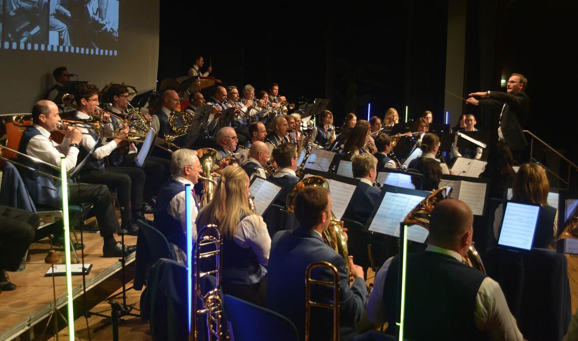 Während im Hintergrund Bilder von früher gezeigt werden, zeigen die Musikerinnen und Musiker des MV Illingen beim Jahreskonzert einmal mehr, was in ihnen steckt. Fotos: Stahlfeld