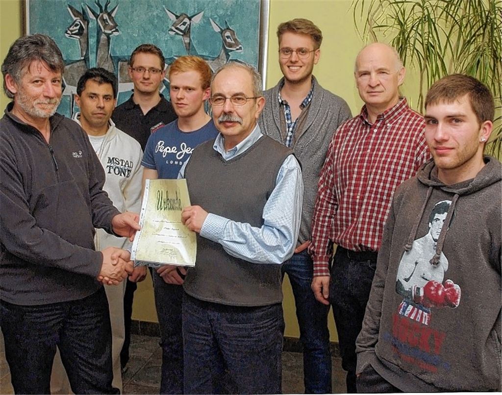 Walter Ruppert (Mitte) wird zum Ehrenmitglied ernannt. Sportwart Thomas Kreutz, Ruben Weiler (Leiter der Abteilung Ju-Jutsu), der Zweite Vorsitzende Tizian Klingel, der Erste Vorsitzende Luis Escolano, Pressewart Gerrit Heilmann, Kassier Enrico Simon und der neue stellvertretende Pressewart Florian Gulyas (v. li. ) bilden das neue Vorstandsgremium von Taekwondo Mühlacker. Foto: Fotomoment
