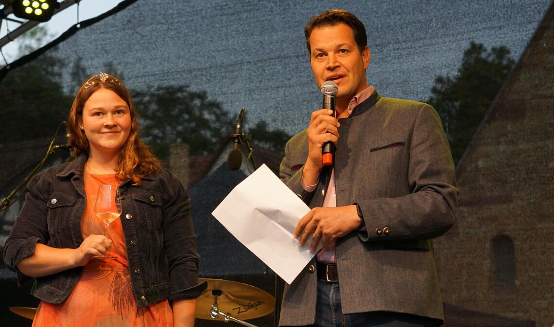 Weinsommer: Anhaltender Regen verdirbt den Durst Weinprinzessin Lisa-Marie Blatt und Bürgermeister Aaron Treut sind mit Blick aufs Wetter bei der Eröffnung des Weinsommers im Maulbronner Klosterhof noch optimistisch. Foto: Bastian